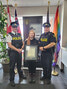 Caitlain McInnes (centre) accepts the Commissioner’s Citation for Bravery on behalf of her late father, Allan McInnes. The citation for Allan McInnes was presented posthumously by Inspector Karl Duewel (left) and Acting Staff Sergeant Russ Saudino (right)