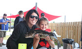 Six-year-old Scarlett Hogan shows off the 4.84 pound walleye she landed with her mom, Kaydi Kondra.    Tim Brody / Bulletin Photo 