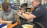 Sioux Lookout OPP, Sioux Lookout Fire Service, and SkyCare air ambulance pilots and paramedics were celebrated as local ‘superheroes’ last week at a Superhero Party at the Sioux Lookout Public Library.     Tim Brody / Bulletin Photo