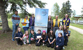 Sioux Lookout Chamber of Commerce Executive Assistant Ninaad Bhatt (standing far left) congratulates the winners of this year’s Take Pride Community Wide campaign, the Sioux Lookout Lions Club (standing back row) and the Sioux Lookout Girls Guides (kneeli