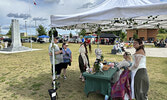 Evelyn Ward (seated) and sister Sarah Ward converse with Renaissance Fair visitors at their booth.     Tim Brody / Bulletin Photo