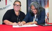 Eagle Lake First Nation Chief Bernadette Wabange (right) signs an MOU with SLFNHA’s CEO and President Sonia Isaac-Mann.   Photo courtesy of SLFNHA