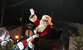 Santa Claus waves to the crowd during last year’s Santa Claus Parade.   Bulletin File Photo