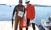 Walleye Weekend volunteer Jennifer Hancharuk (right) poses for a photo with angler Dave Button.     Tim Brody / Bulletin Photo 